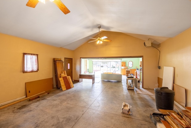 living area with concrete floors, a ceiling fan, and vaulted ceiling