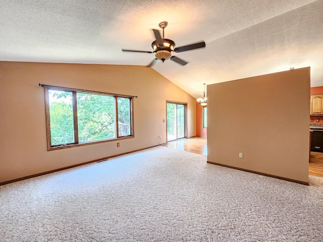 908 Park Ln, Belle Plaine, MN 56011 - unfurnished room featuring light carpet, lofted ceiling, a ceiling fan, plenty of natural light, and a textured ceiling