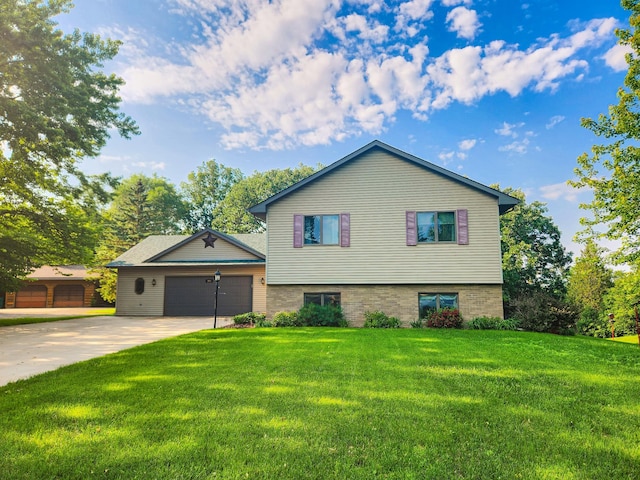 908 Park Ln, Belle Plaine, MN 56011 - tri-level home with concrete driveway, a front yard, and an attached garage
