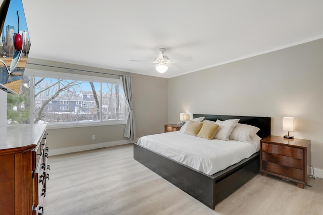 bedroom with light wood-type flooring, baseboards, and ceiling fan