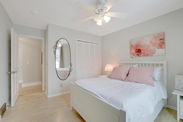 bedroom with a ceiling fan, light wood-style floors, a closet, and baseboards