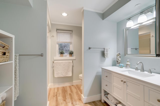 full bath with baseboards, toilet, ornamental molding, wood finished floors, and vanity