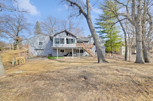 rear view of house with stairway and a wooden deck