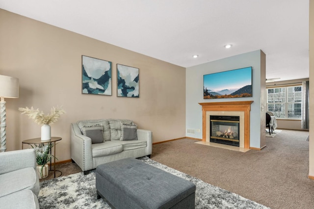 carpeted living room featuring recessed lighting, a tile fireplace, and baseboards