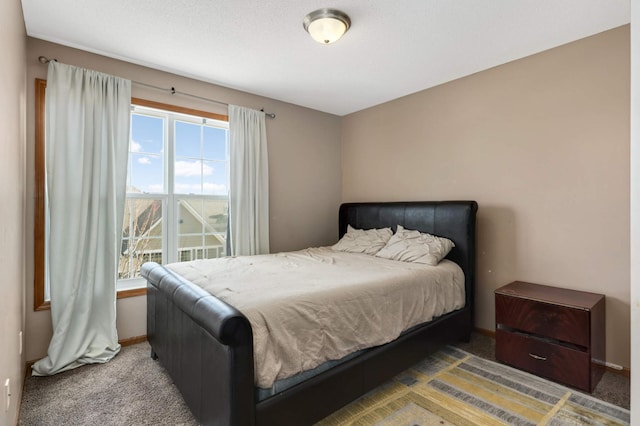 bedroom with carpet floors and baseboards