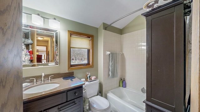 full bathroom with toilet, lofted ceiling, vanity, and bathtub / shower combination