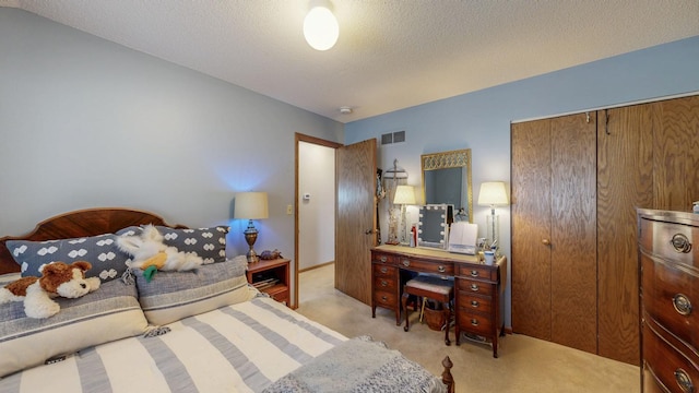 carpeted bedroom featuring a textured ceiling, visible vents, and a closet