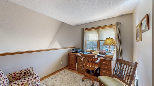 home office with baseboards, wood finished floors, and a textured ceiling