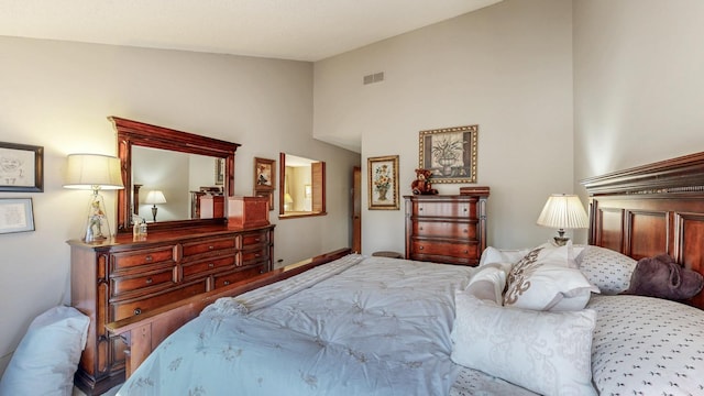 bedroom with lofted ceiling and visible vents