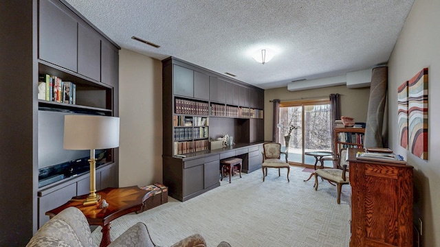 living area featuring a textured ceiling and visible vents