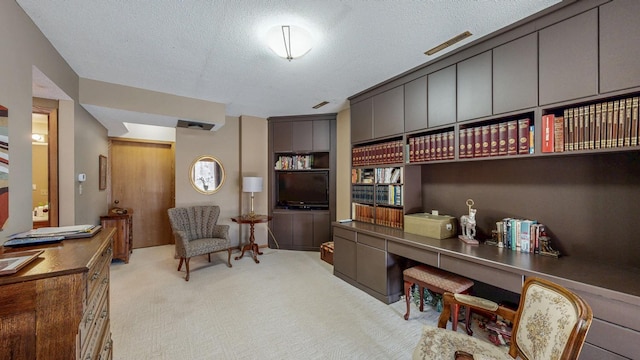 home office featuring light carpet, visible vents, and a textured ceiling