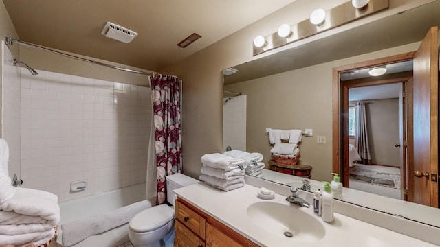 bathroom featuring shower / tub combo, toilet, vanity, and visible vents