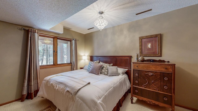 bedroom featuring baseboards, visible vents, light colored carpet, and a notable chandelier