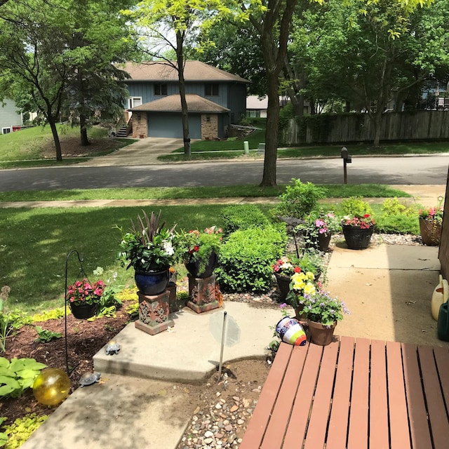 view of yard featuring a garage and fence