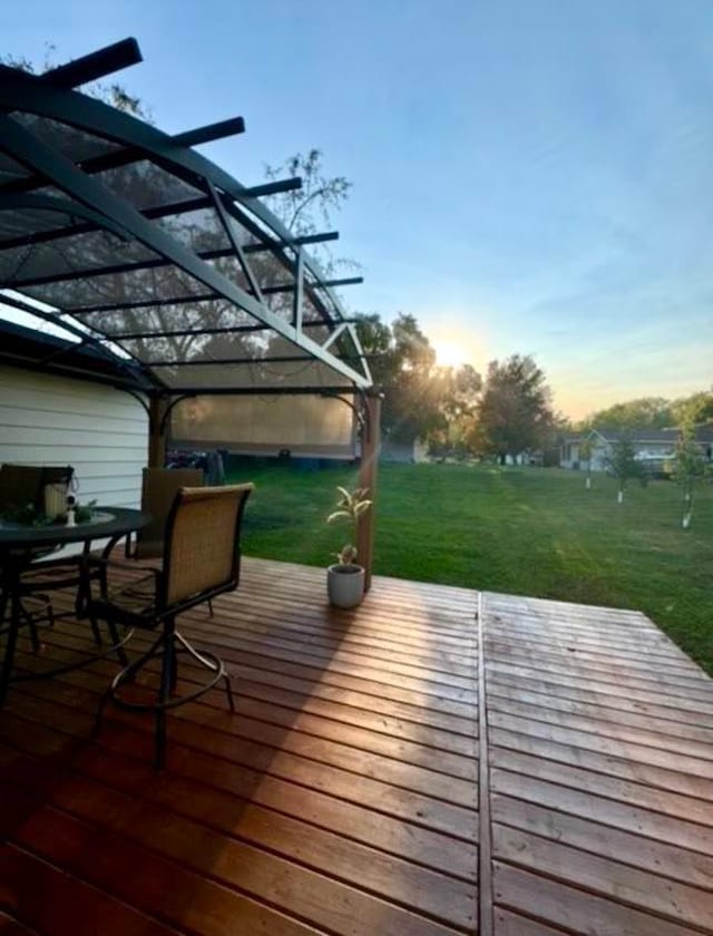 wooden deck featuring outdoor dining area, a lawn, and a pergola