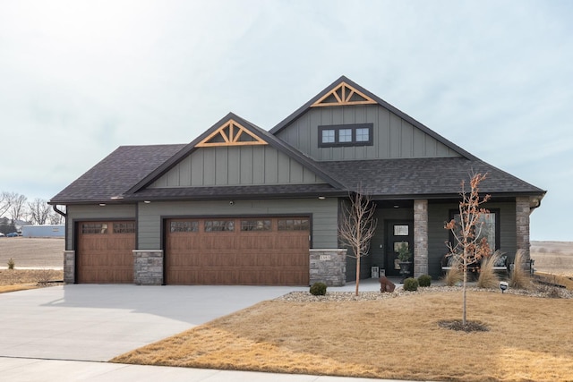 craftsman inspired home with an attached garage, stone siding, a shingled roof, and concrete driveway