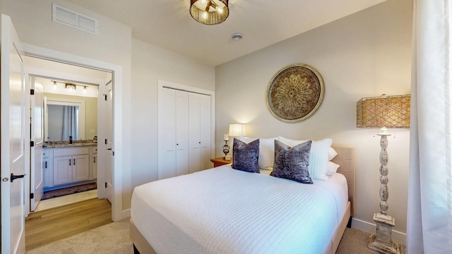 bedroom with vaulted ceiling, a closet, visible vents, and baseboards