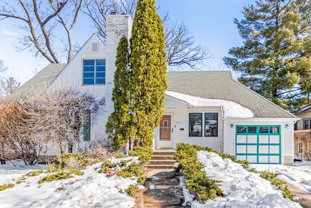 view of front of home featuring a chimney and an attached garage