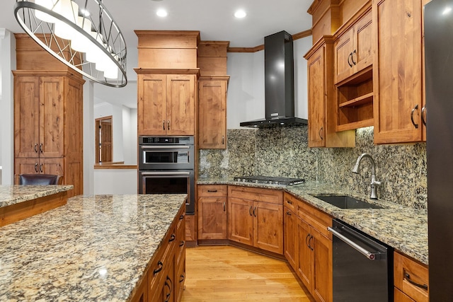 kitchen featuring double wall oven, a sink, wall chimney range hood, dishwasher, and stainless steel gas stovetop