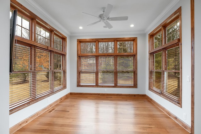 unfurnished sunroom with a healthy amount of sunlight and a ceiling fan