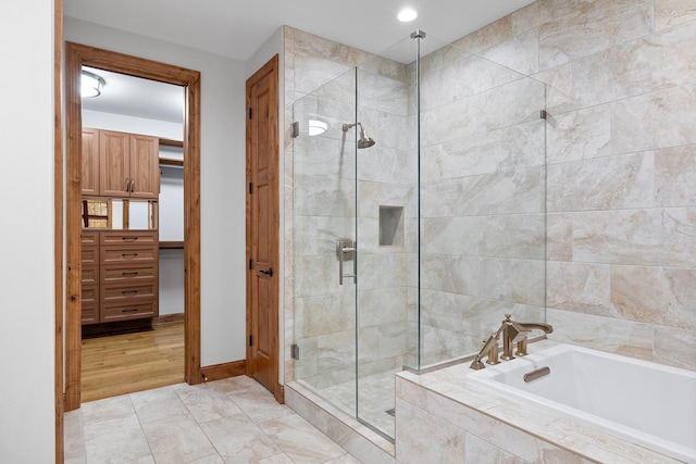 bathroom featuring a stall shower and a garden tub