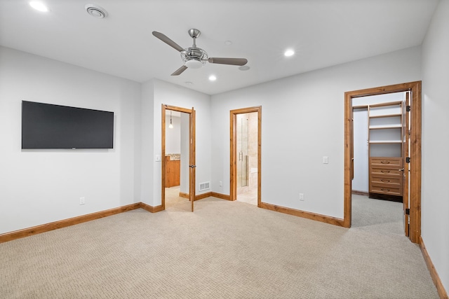 unfurnished bedroom featuring carpet floors, recessed lighting, visible vents, a spacious closet, and baseboards