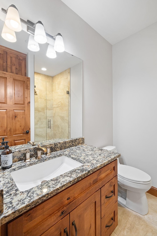 full bath featuring vanity, a shower stall, and toilet