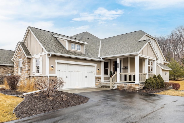 1328 Riverside Ln, Mendota Heights, MN 55118 - view of front of house with driveway, stone siding, a porch, board and batten siding, and roof with shingles