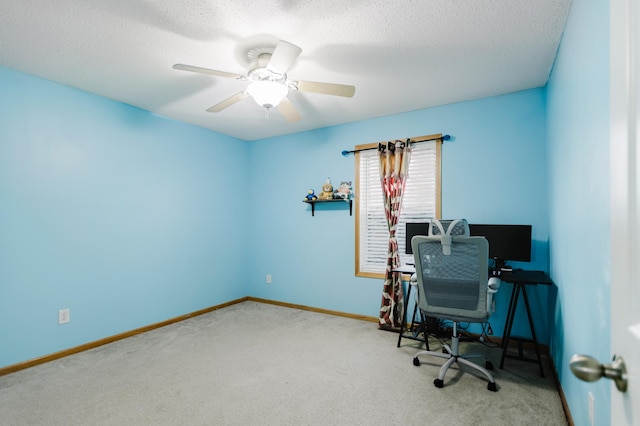 home office featuring baseboards, carpet, ceiling fan, and a textured ceiling