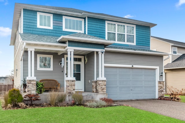 view of front facade with a porch, stone siding, driveway, and an attached garage