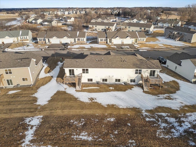 snowy aerial view featuring a residential view