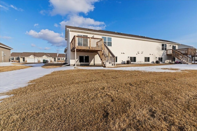 back of property with a lawn and stairs