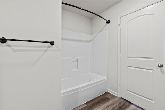 full bath featuring  shower combination and wood finished floors