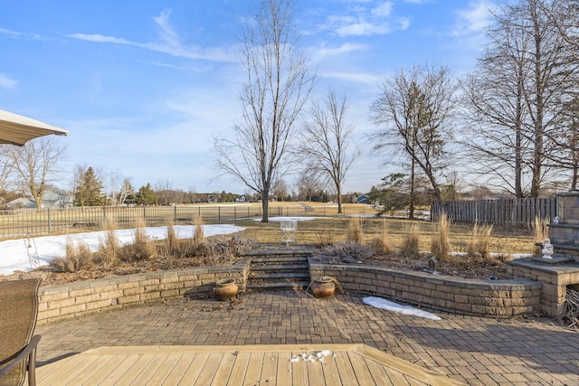 wooden terrace featuring a patio and fence