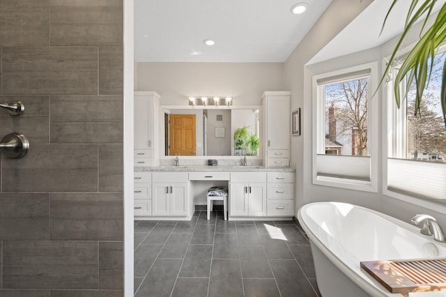 full bathroom featuring tile patterned floors, a freestanding tub, recessed lighting, tiled shower, and vanity