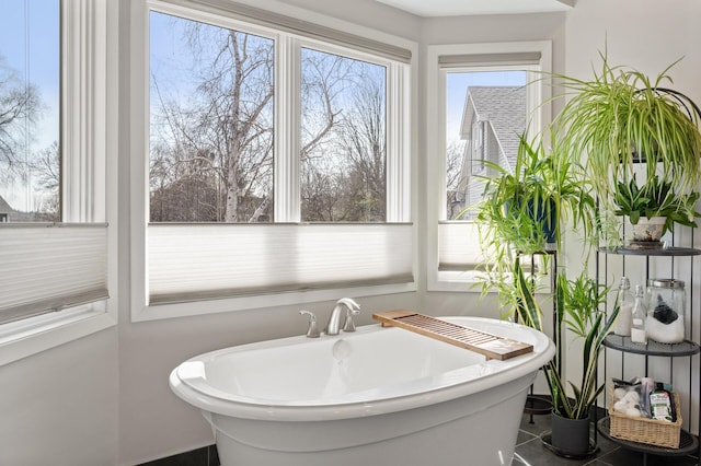 full bathroom with tile patterned flooring and a soaking tub