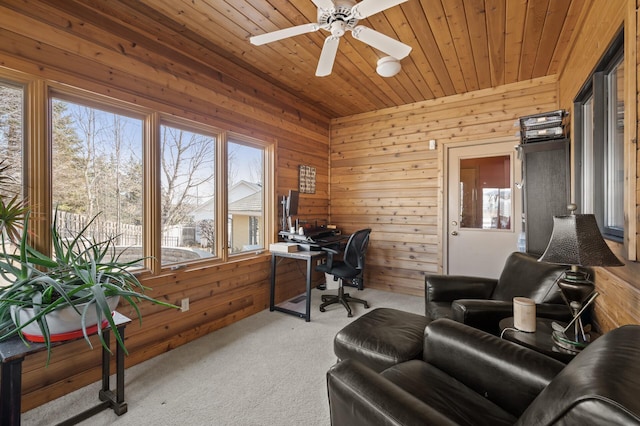 office area featuring carpet, wood ceiling, wood walls, and a ceiling fan