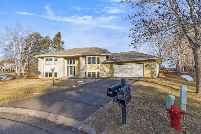 view of front of home with aphalt driveway, stone siding, a front yard, and an attached garage