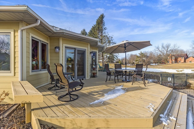 wooden deck with outdoor dining area and fence