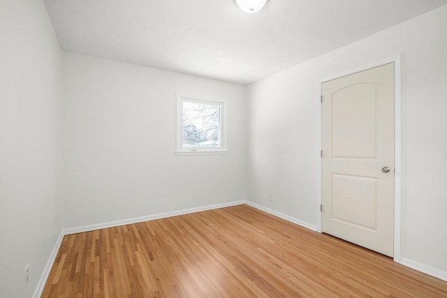 empty room featuring light wood-style flooring and baseboards