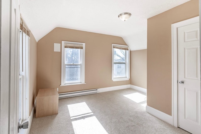 additional living space featuring baseboards, a baseboard heating unit, carpet floors, and lofted ceiling