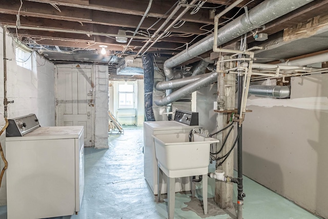 basement with independent washer and dryer and a sink