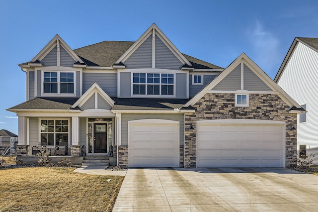 view of front facade featuring stone siding, concrete driveway, and roof with shingles