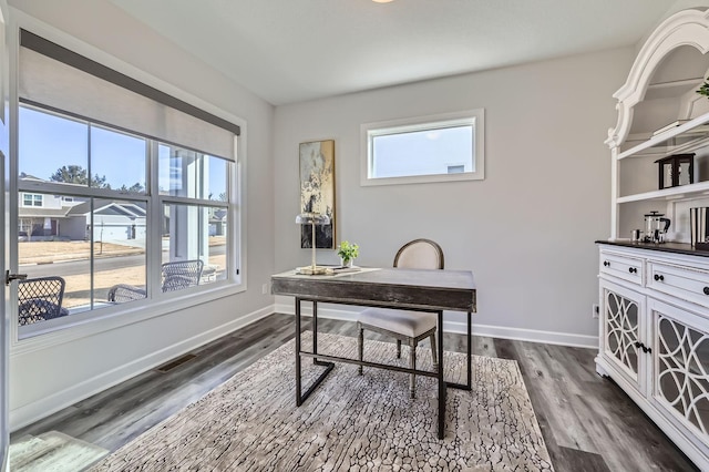 office with visible vents, dark wood finished floors, and baseboards