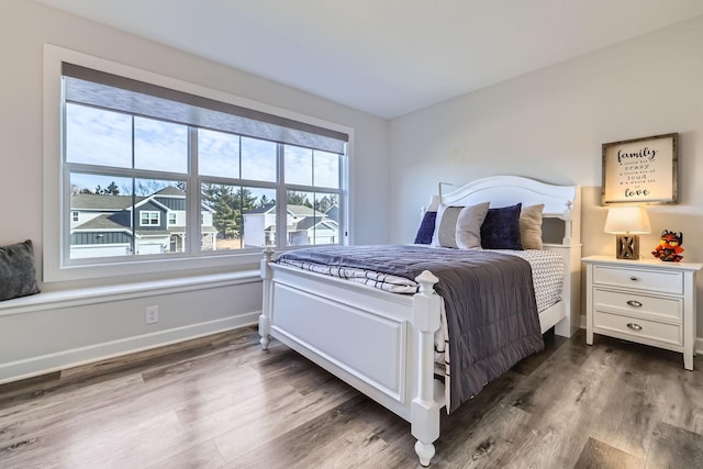 bedroom featuring baseboards and dark wood finished floors