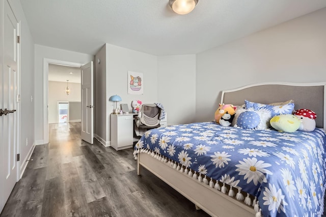 bedroom with wood finished floors and baseboards