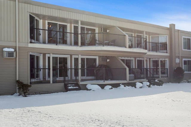 view of snow covered back of property