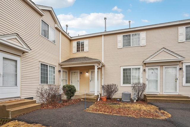 view of front of house with entry steps and central AC