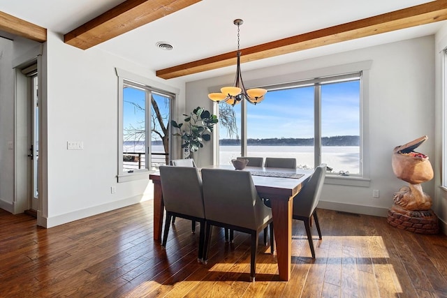 dining room with a chandelier, wood-type flooring, a healthy amount of sunlight, and beamed ceiling