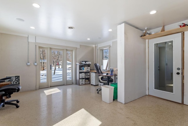 home office featuring speckled floor, concrete block wall, visible vents, and recessed lighting